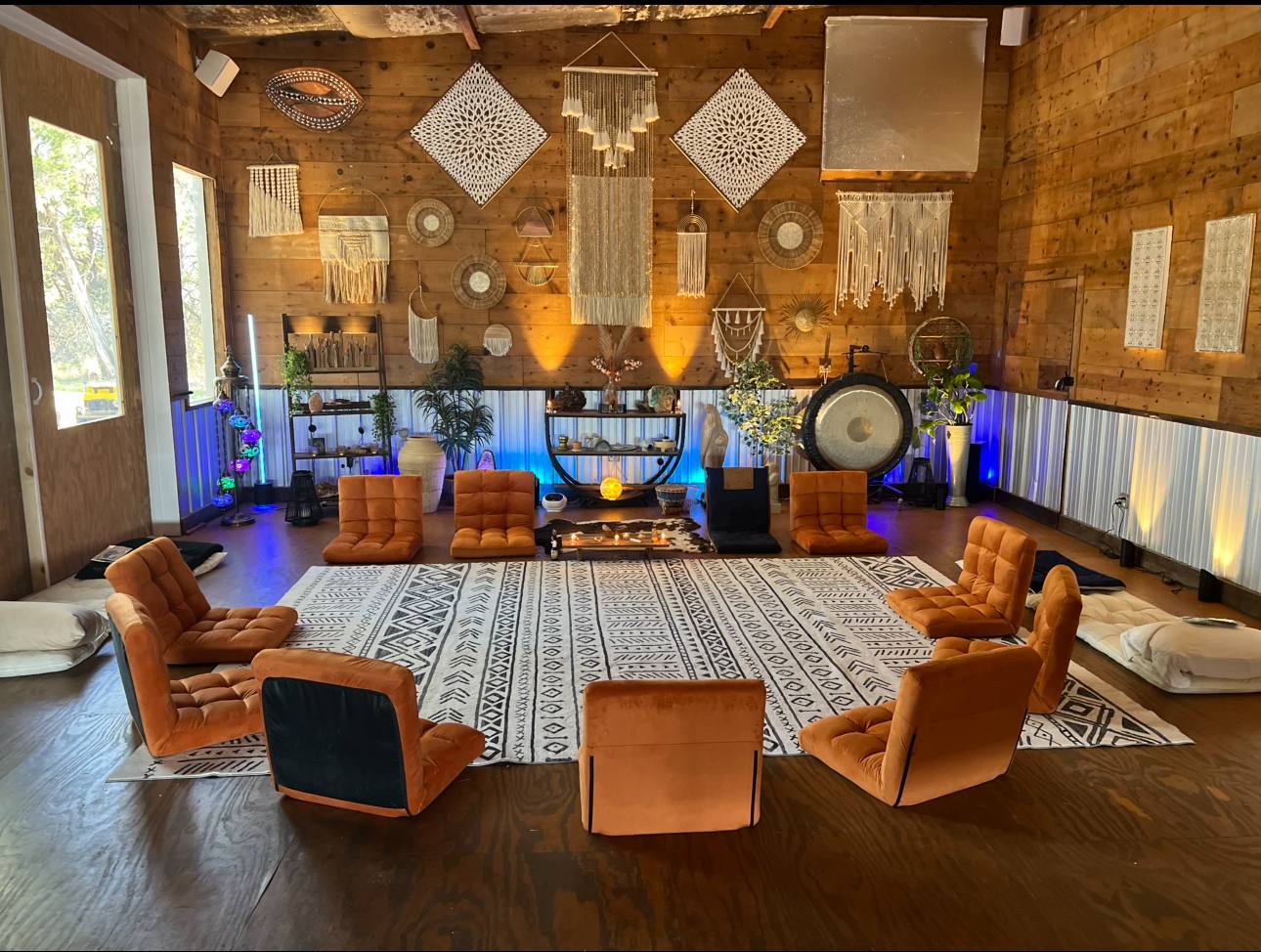 The ceremony room, cushions set in circle around the fire and gong